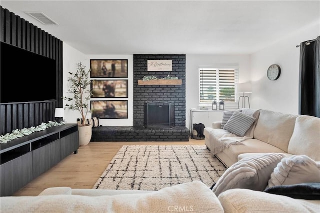21046 Lone Eagle Rd, Apple Valley, CA 92308 - living room featuring wood finished floors and a brick fireplace