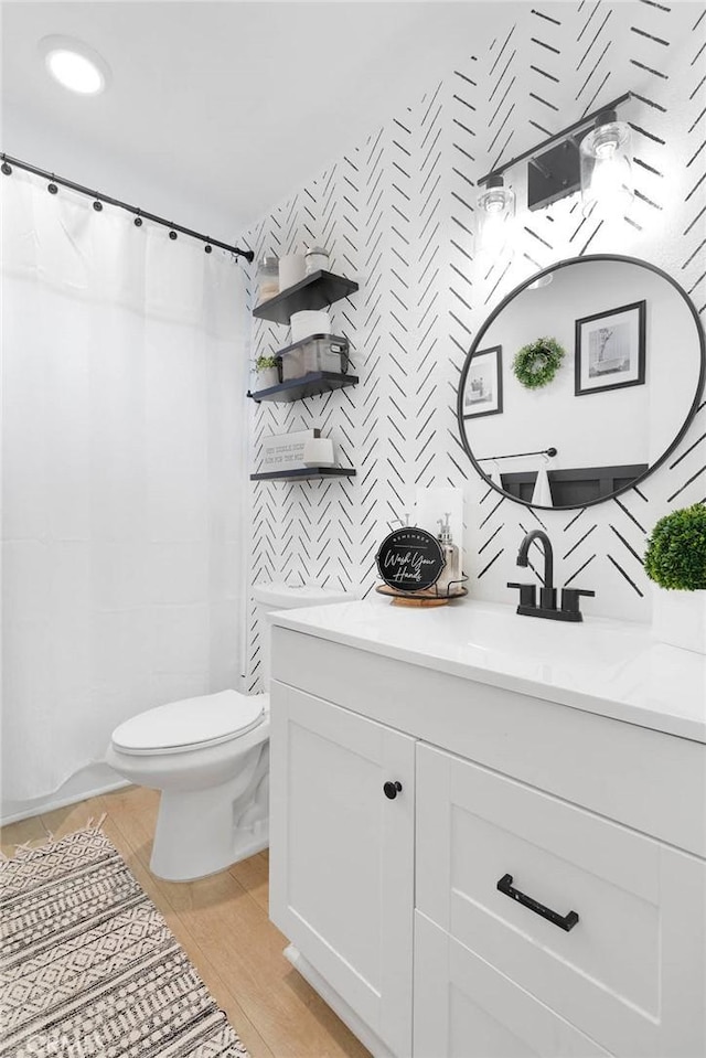 21046 Lone Eagle Rd, Apple Valley, CA 92308 - bathroom featuring toilet, vanity, wallpapered walls, and curtained shower