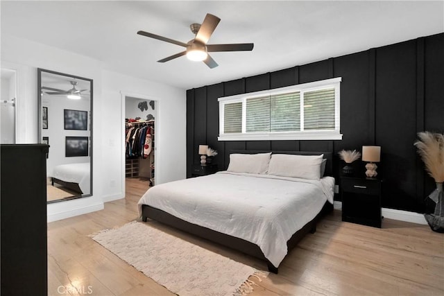 21046 Lone Eagle Rd, Apple Valley, CA 92308 - bedroom with light wood-style flooring, a walk in closet, a closet, ceiling fan, and baseboards