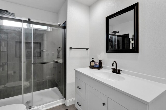 21046 Lone Eagle Rd, Apple Valley, CA 92308 - bathroom with a shower stall, vanity, and toilet