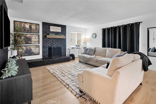 21046 Lone Eagle Rd, Apple Valley, CA 92308 - living room with wood finished floors and a fireplace