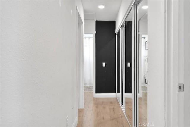 21046 Lone Eagle Rd, Apple Valley, CA 92308 - corridor with light wood-style floors, baseboards, and a textured wall