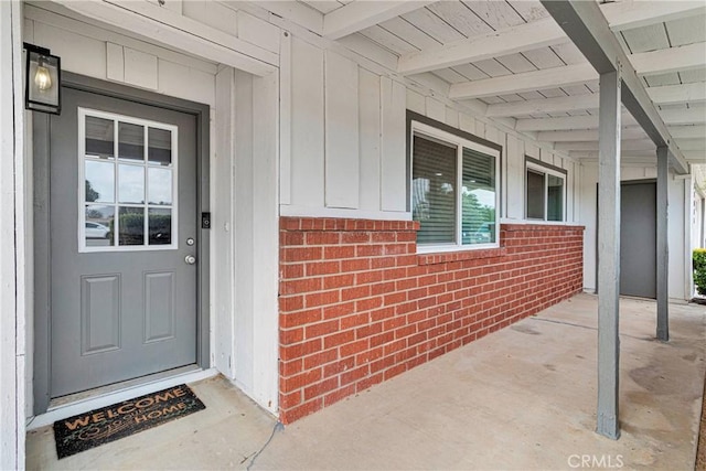 21046 Lone Eagle Rd, Apple Valley, CA 92308 - entrance to property with board and batten siding, brick siding, and covered porch