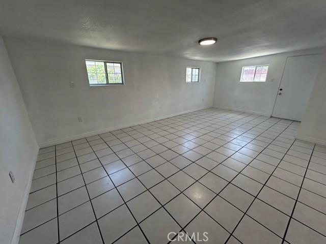 8960 Indiana Ave, Riverside, CA 92503 - spare room featuring light tile patterned floors and baseboards