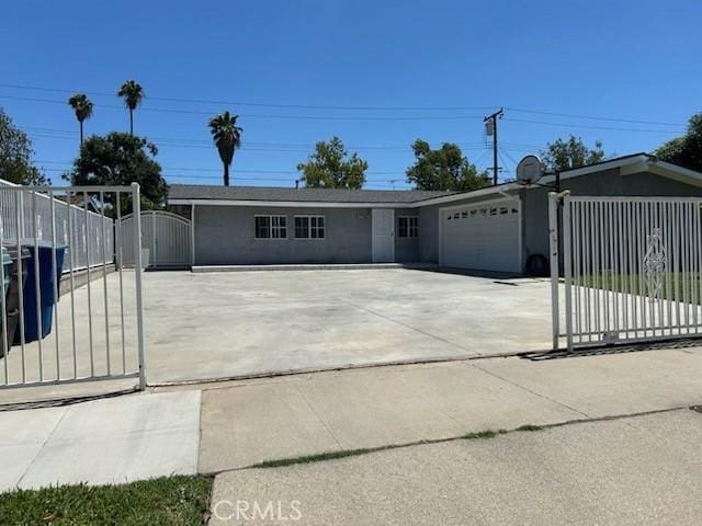 8960 Indiana Ave, Riverside, CA 92503 - view of front of property featuring a garage, driveway, a gate, and fence