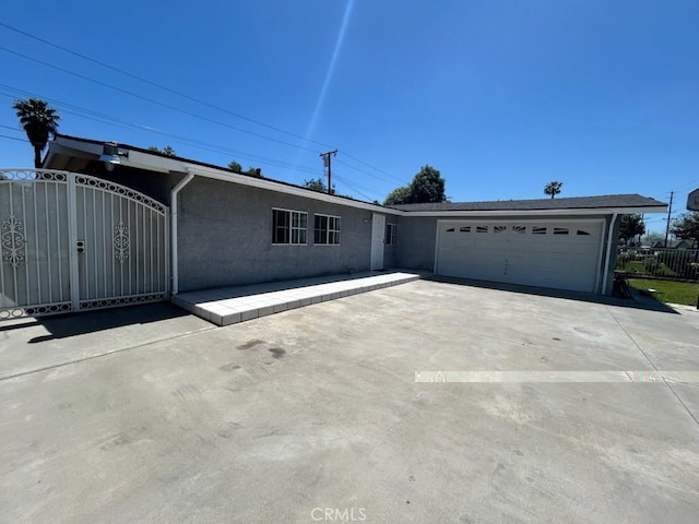 8960 Indiana Ave, Riverside, CA 92503 - ranch-style home featuring stucco siding, driveway, and an attached garage