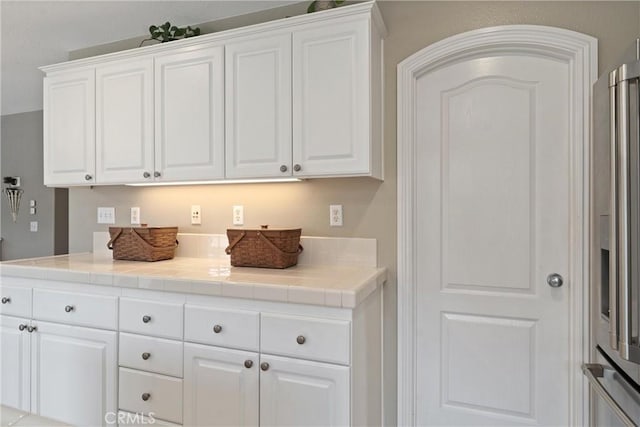 5549 Pine Ave, Chino Hills, CA 91709 - kitchen with white cabinets, tile countertops, and stainless steel refrigerator with ice dispenser