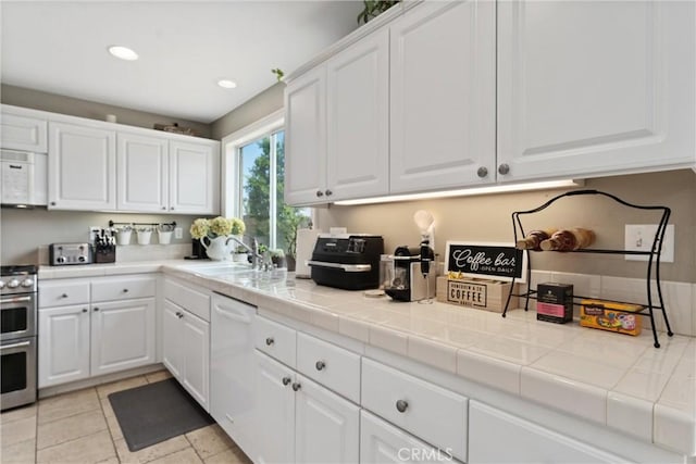 5549 Pine Ave, Chino Hills, CA 91709 - kitchen with white appliances, white cabinets, recessed lighting, and tile countertops