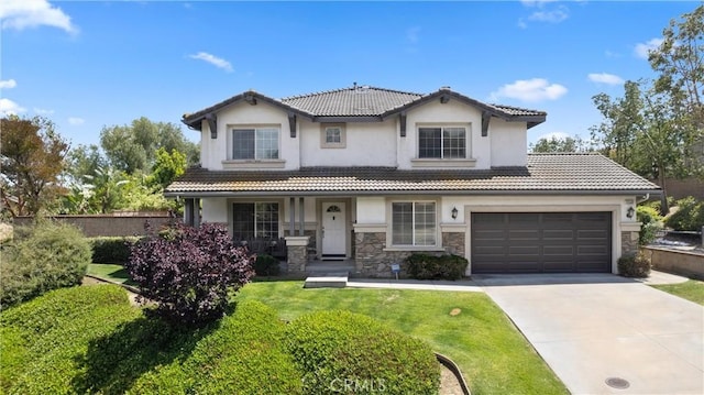 5549 Pine Ave, Chino Hills, CA 91709 - view of front of home featuring driveway, stucco siding, a tile roof, and stone siding