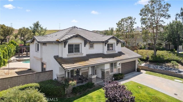 5549 Pine Ave, Chino Hills, CA 91709 - view of front of house with concrete driveway, a tiled roof, a porch, and stucco siding