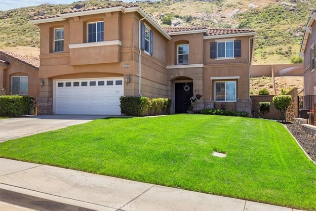 16549 Gala Ave, Fontana, CA 92337 - mediterranean / spanish home featuring a mountain view, stucco siding, and a garage