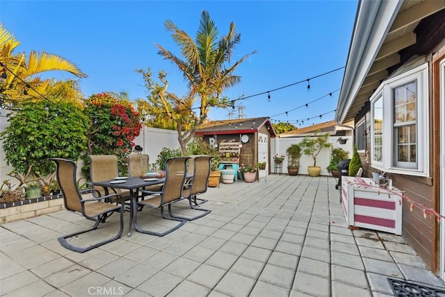 21372 Sand Dollar Ln, Huntington Beach, CA 92646 - view of patio featuring a fenced backyard, an outdoor structure, a shed, and outdoor dining space