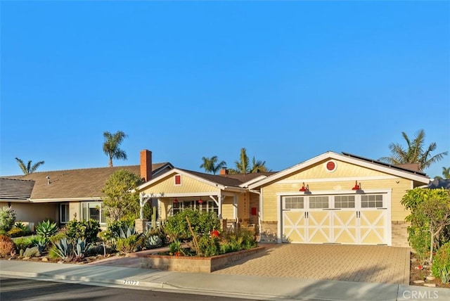 21372 Sand Dollar Ln, Huntington Beach, CA 92646 - single story home with decorative driveway, an attached garage, and roof mounted solar panels