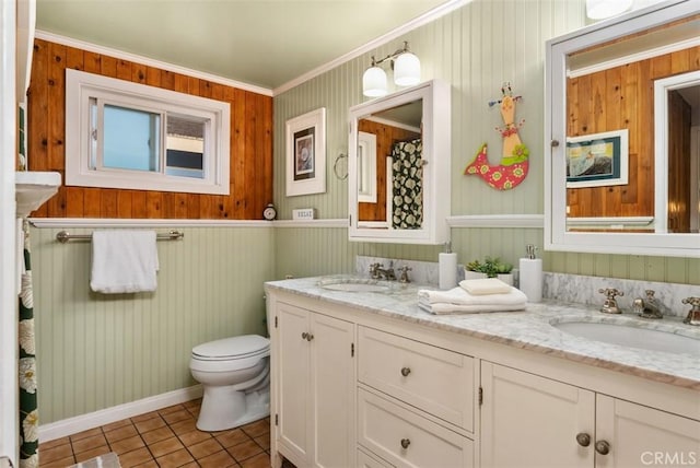 21372 Sand Dollar Ln, Huntington Beach, CA 92646 - bathroom featuring toilet, tile patterned flooring, double vanity, crown molding, and wooden walls