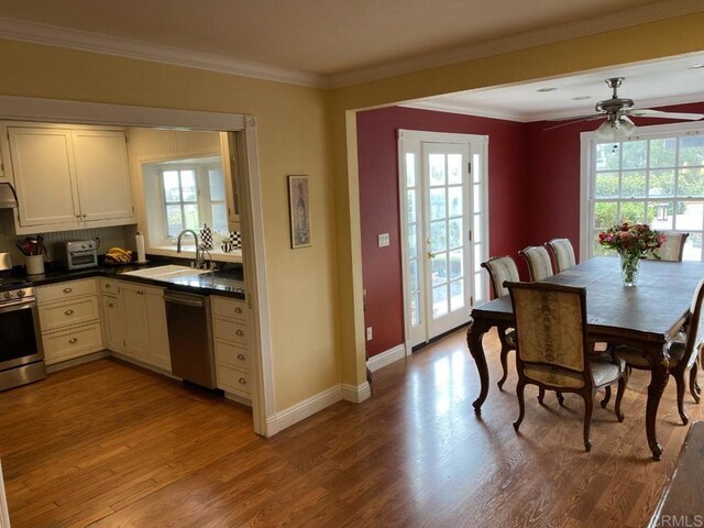 6172 Tamilynn St, San Diego, CA 92122 - dining area with wood finished floors, ceiling fan, baseboards, and ornamental molding