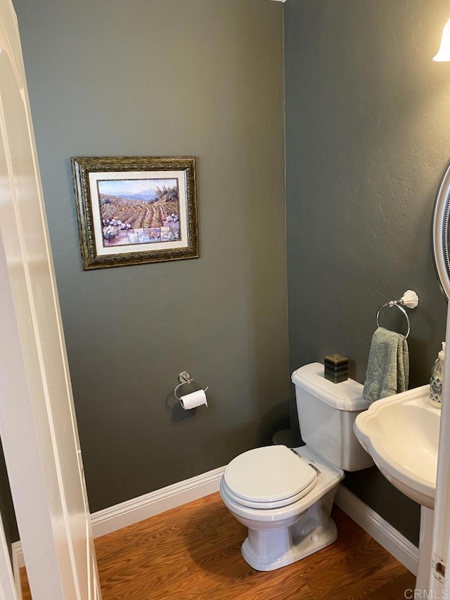 6172 Tamilynn St, San Diego, CA 92122 - half bathroom featuring wood finished floors, toilet, baseboards, and a sink