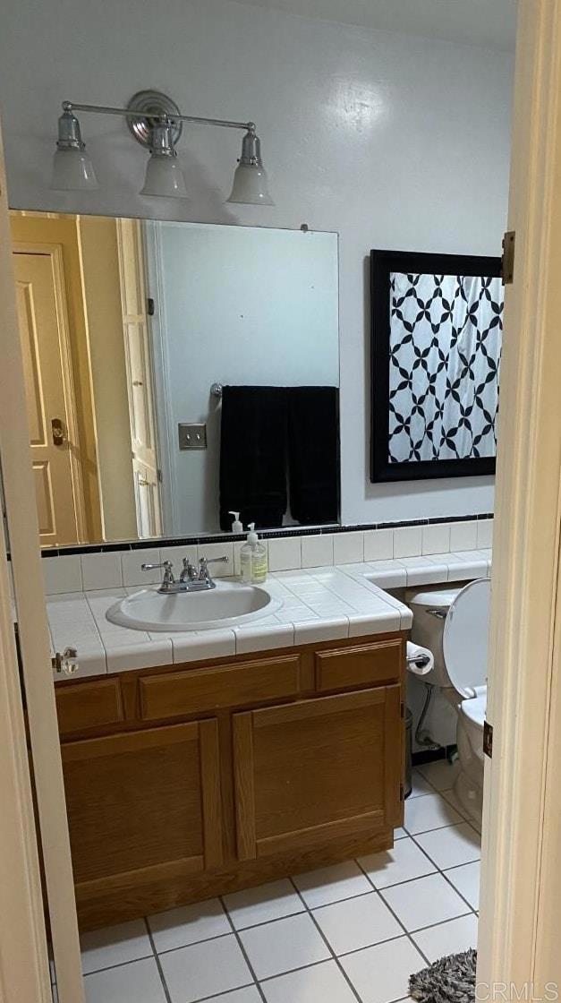 6172 Tamilynn St, San Diego, CA 92122 - bathroom with tile patterned flooring, toilet, and vanity