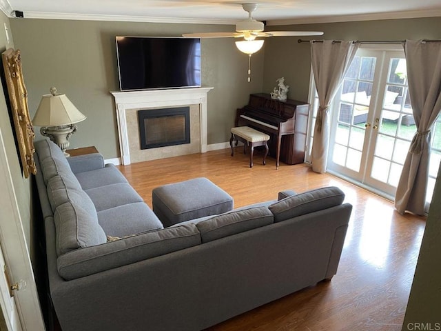 6172 Tamilynn St, San Diego, CA 92122 - living room with crown molding, wood finished floors, ceiling fan, a fireplace, and baseboards