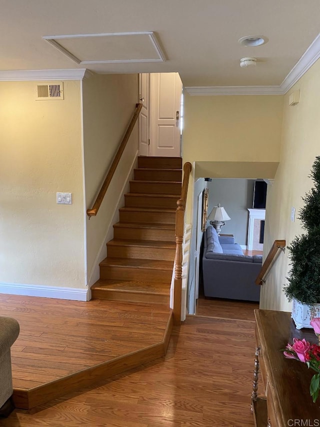 6172 Tamilynn St, San Diego, CA 92122 - stairway featuring wood finished floors, attic access, crown molding, and baseboards