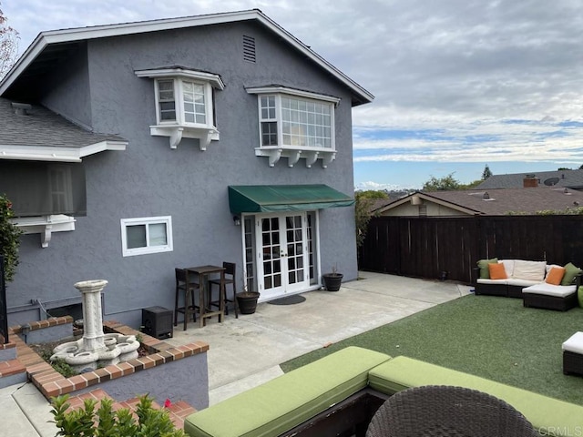 6172 Tamilynn St, San Diego, CA 92122 - back of house with french doors, fence, stucco siding, and a patio area
