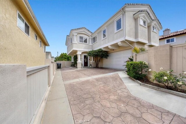 1817 Clark Ln Unit B, Redondo Beach, CA 90278 - view of front of home featuring a garage, stucco siding, fence, and driveway