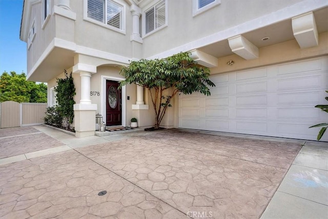 1817 Clark Ln Unit B, Redondo Beach, CA 90278 - view of exterior entry featuring stucco siding, a garage, and driveway