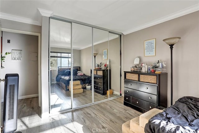 1118 Valencia St Unit 216, Los Angeles, CA 90015 - bedroom featuring ornamental molding, wood finished floors, a closet, and baseboards