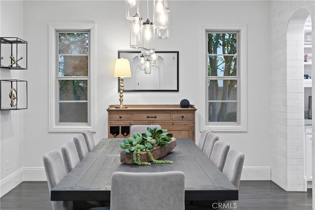 12 Via Alcamo, San Clemente, CA 92673 - dining area featuring arched walkways, baseboards, dark wood-style flooring, and plenty of natural light