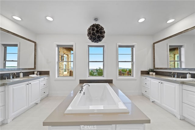 12 Via Alcamo, San Clemente, CA 92673 - full bath featuring plenty of natural light, baseboards, two vanities, a bath, and recessed lighting