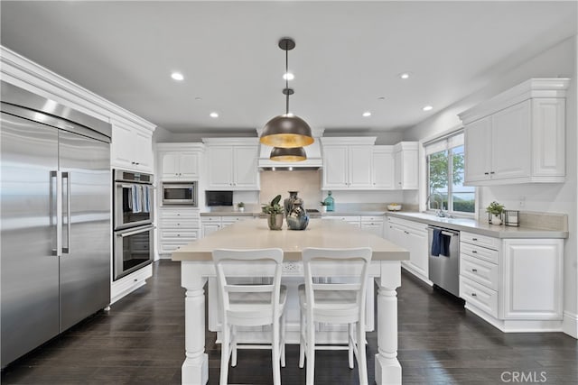 12 Via Alcamo, San Clemente, CA 92673 - kitchen with built in appliances, recessed lighting, white cabinets, light countertops, and dark wood finished floors
