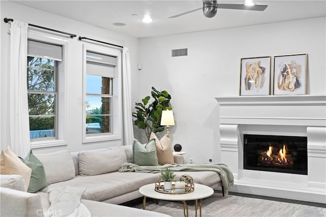 12 Via Alcamo, San Clemente, CA 92673 - living room with wood finished floors, plenty of natural light, ceiling fan, and a warm lit fireplace