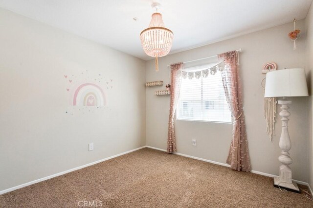 5354 Wrangler Dr, Fontana, CA 92336 - unfurnished room with carpet and a chandelier