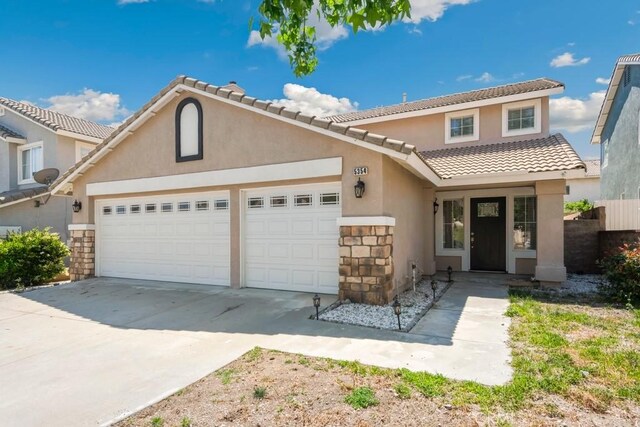 5354 Wrangler Dr, Fontana, CA 92336 - view of front of house with a garage, concrete driveway, stucco siding, and a tiled roof