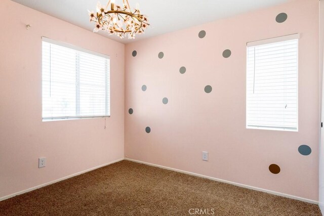 5354 Wrangler Dr, Fontana, CA 92336 - carpeted spare room featuring a chandelier and baseboards