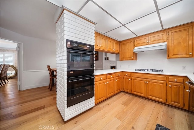 780 Brown Sage Dr, Glendora, CA 91741 - kitchen featuring under cabinet range hood, white gas stovetop, light wood finished floors, light countertops, and brown cabinets