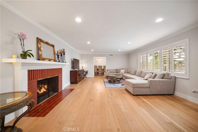780 Brown Sage Dr, Glendora, CA 91741 - living room featuring light wood finished floors, a brick fireplace, baseboards, recessed lighting, and crown molding