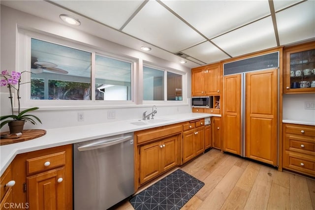 780 Brown Sage Dr, Glendora, CA 91741 - kitchen featuring appliances with stainless steel finishes, a sink, brown cabinets, light wood finished floors, and light countertops