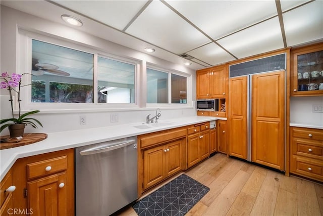 780 Brown Sage Dr, Glendora, CA 91741 - kitchen with stainless steel appliances, brown cabinetry, light wood-style floors, light countertops, and recessed lighting