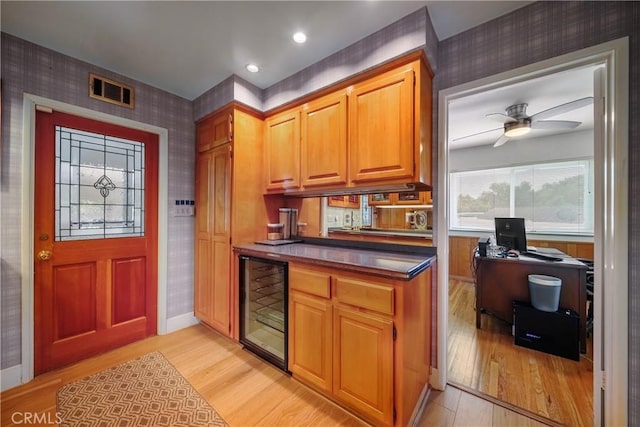 780 Brown Sage Dr, Glendora, CA 91741 - kitchen with wallpapered walls, beverage cooler, light wood finished floors, a ceiling fan, and dark countertops