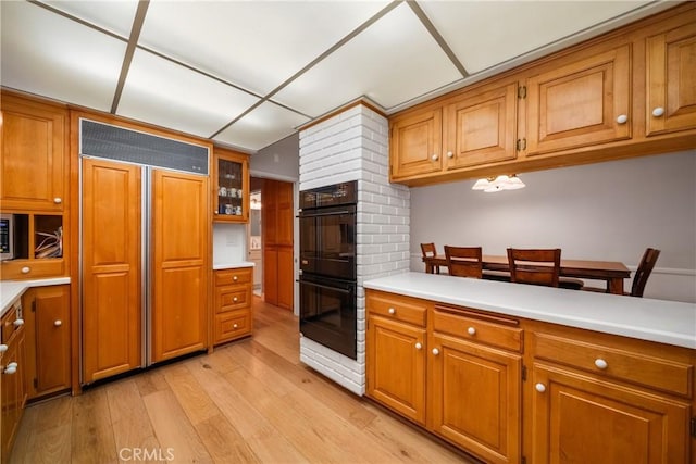 780 Brown Sage Dr, Glendora, CA 91741 - kitchen with built in refrigerator, brown cabinets, light wood-style flooring, and light countertops