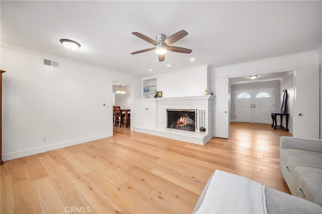 780 Brown Sage Dr, Glendora, CA 91741 - unfurnished living room featuring a ceiling fan, light wood-style floors, ornamental molding, a brick fireplace, and baseboards