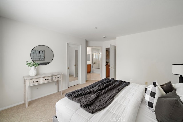 bedroom with light carpet, baseboards, and ensuite bathroom