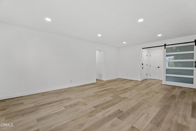 6721 S Springpark Ave Unit 3A, Los Angeles, CA 90056 - spare room featuring a barn door, light wood-style flooring, recessed lighting, and baseboards