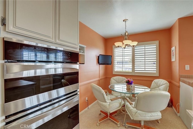 3511 Daffodil Ave Unit 14, Corona Del Mar, CA 92625 - carpeted dining space featuring a chandelier and baseboards