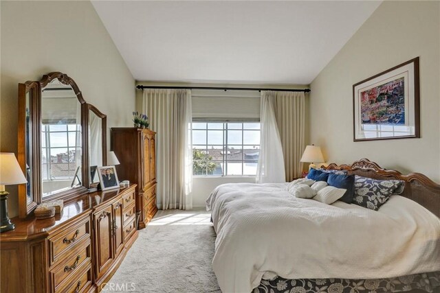 3511 Daffodil Ave Unit 14, Corona Del Mar, CA 92625 - bedroom featuring multiple windows, vaulted ceiling, and light colored carpet