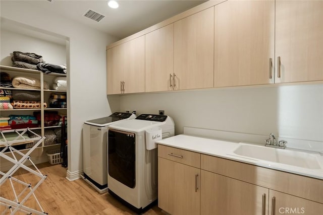 32106 Richardson St, Menifee, CA 92584 - laundry area featuring cabinet space, washer and clothes dryer, light wood-style flooring, and recessed lighting