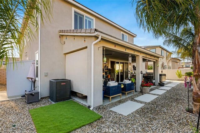 32106 Richardson St, Menifee, CA 92584 - back of property featuring central air condition unit, a patio area, stucco siding, a fenced backyard, and ceiling fan