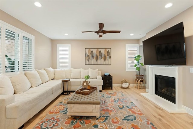 32106 Richardson St, Menifee, CA 92584 - living room with a ceiling fan, wood finished floors, recessed lighting, a glass covered fireplace, and baseboards