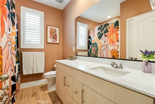 32106 Richardson St, Menifee, CA 92584 - full bathroom with toilet, wood finished floors, vanity, baseboards, and a shower with curtain