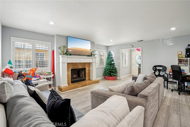 3336 Cherokee Ave, South Gate, CA 90280 - living area featuring light wood-type flooring, recessed lighting, a tile fireplace, and baseboards